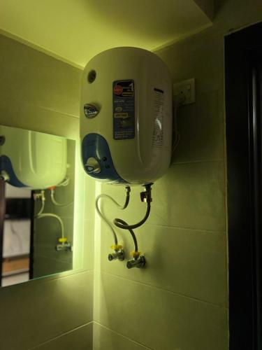 a phone is on the wall of a bathroom at Penta Square Superior Executive Apartments-DHA Lahore in Lahore