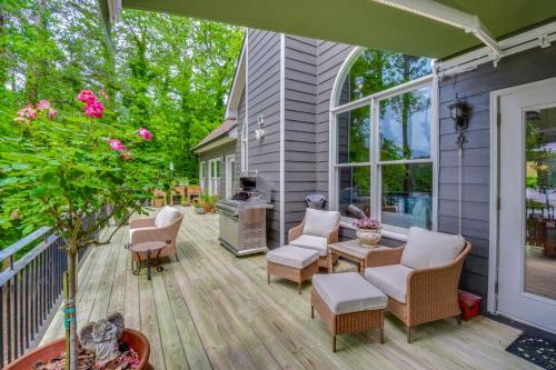 a patio with chairs and a grill on a house at Home on Lake Lanier with Dock and Water Views in Gainesville