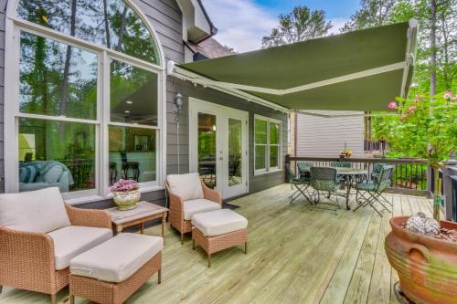 an outdoor patio with chairs and a table at Home on Lake Lanier with Dock and Water Views in Gainesville