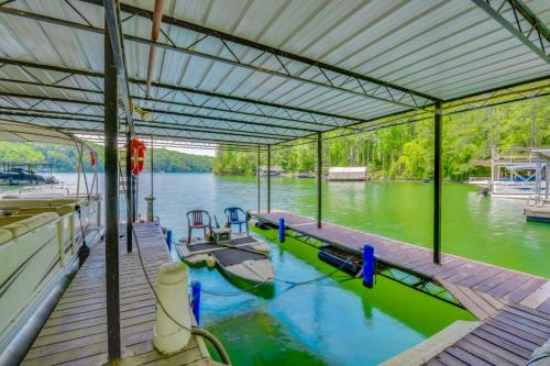 a dock with a boat on the water at Home on Lake Lanier with Dock and Water Views in Gainesville
