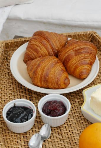a plate of croissants and jam on a table at Penta Square Superior Executive Apartments-DHA Lahore in Lahore
