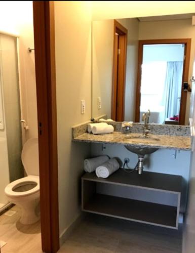 a bathroom with a sink and a toilet at Salinas Park Resort in Salinópolis