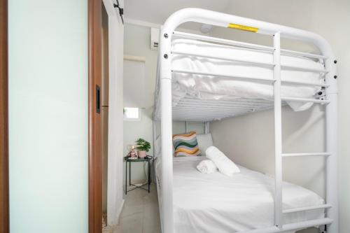 a bunk bed in a room with a white bunk bed at Room 6 Affordable Cool in Santurce Arts Area in San Juan