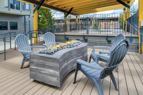 three chairs and a table on a deck at Wedgewood Lodge in Breckenridge