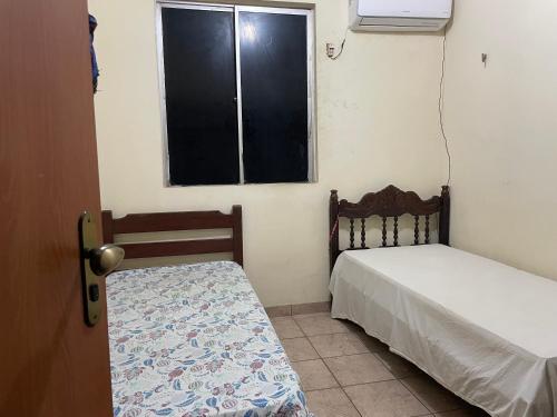 a bedroom with a bed and a window and a bed sidx sidx sidx at Ap COP 30 in Ananindeua