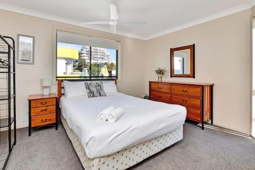a bedroom with a large bed and a window at Palm Beach 33B Shoal Bay Road in Shoal Bay