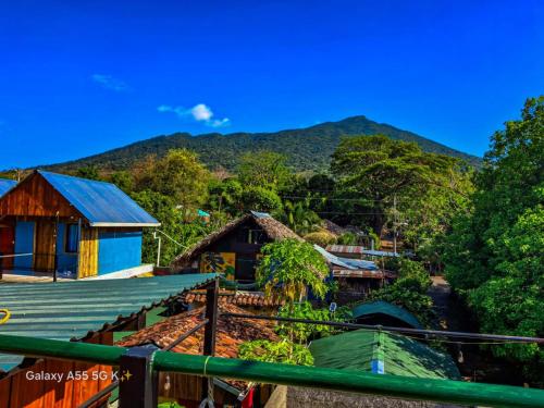 a view of a village with mountains in the background at Lazy Crab Hostel in Balgue