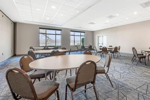 a room with tables and chairs and windows at Holiday Inn Express Hotel & Suites Astoria by IHG in Astoria, Oregon