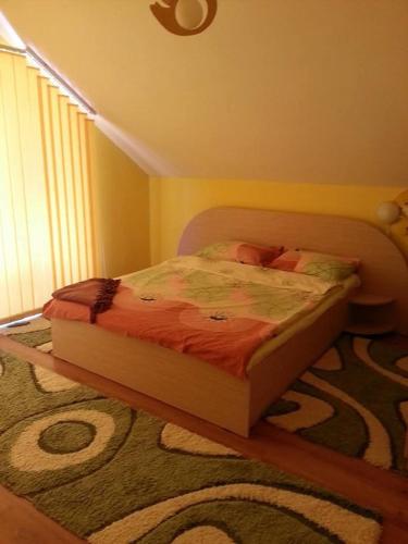 a bed in a bedroom with a rug at Casa Brad Sovata in Sovata