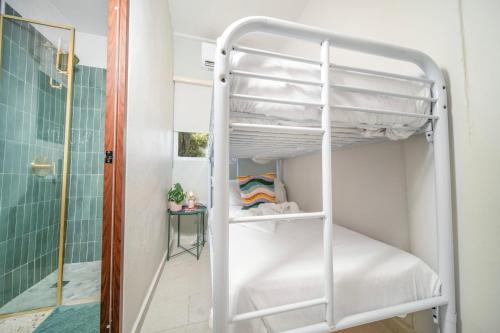 a bunk bed in a bathroom next to a shower at Room 8 Colorful Crash Pad Near Cerra Art in San Juan