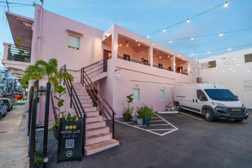 a white van parked in front of a pink house at Room 8 Colorful Crash Pad Near Cerra Art in San Juan