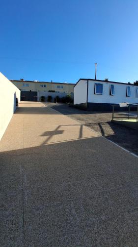 an empty parking lot with a building in the background at Cute House Marinho in Santa Maria da Feira