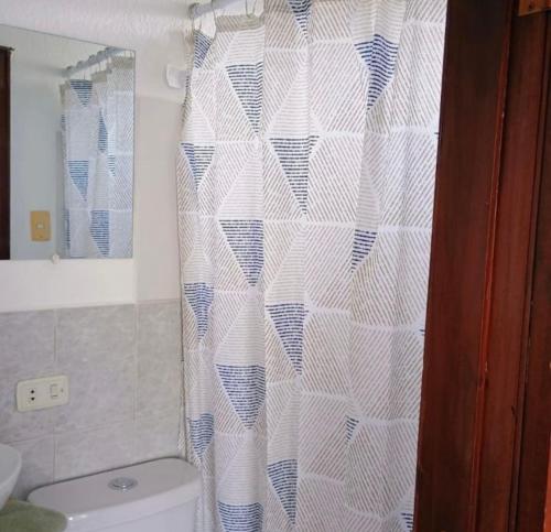 a bathroom with a toilet and a shower curtain at centrico departamento in Cusco