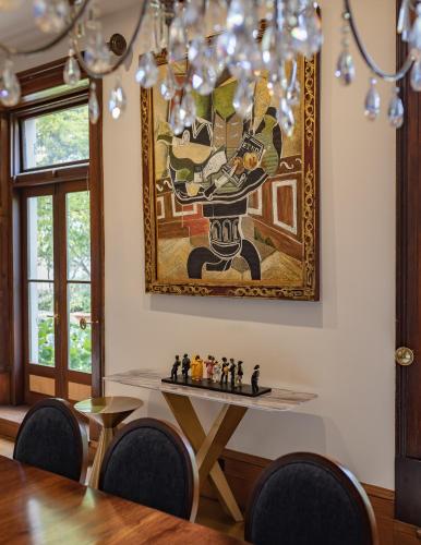 a dining room with a table and a painting on the wall at Islington Hotel in Hobart