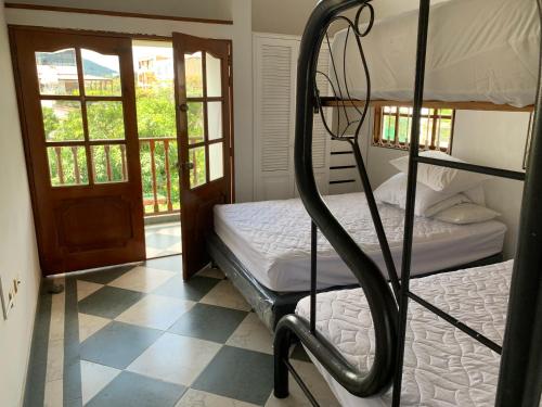 a bedroom with two bunk beds and a doorway at Refugio de Paz Casa en Anapoima in Anapoima