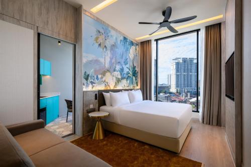 a bedroom with a white bed and a large window at Fifth Avenue Hotel in George Town