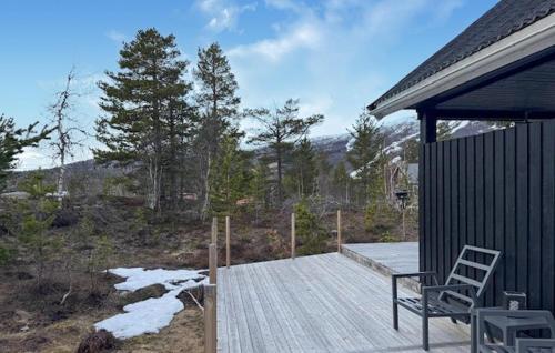 a wooden deck with a chair on top of a house at Stunning Home In Bjorli With Wifi in Bjorli