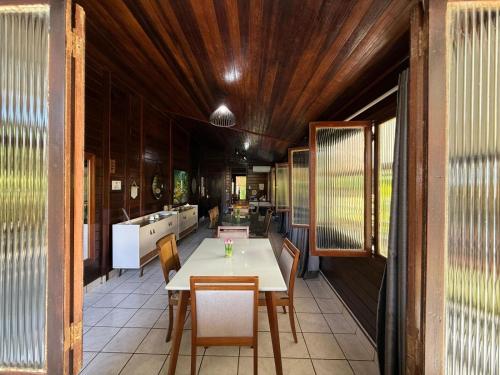 a dining room with a table and chairs at Pousada das Flores in Fernando de Noronha