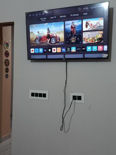 a flat screen tv on a white wall at Hotel Girja Sagar in Patna