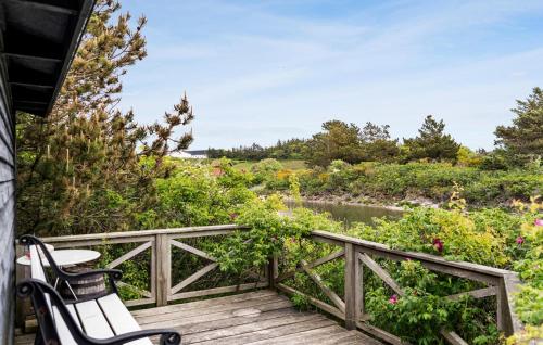 a deck with two chairs and a view of a river at 5 Bedroom Awesome Home In Vestervig in Vestervig