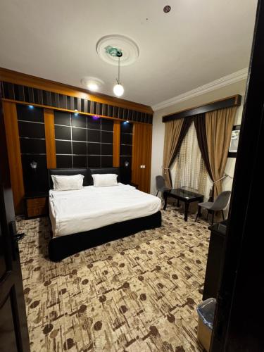 a bedroom with a bed and a desk and a couch at شقق فايا in Jazan