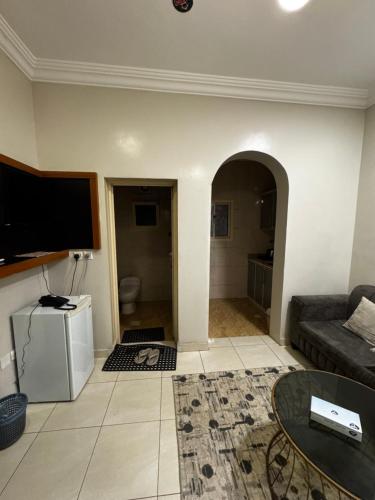 a living room with a couch and a tv at شقق فايا in Jazan