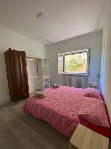 a bedroom with a large bed and a window at Villa la Palma in Gemonio