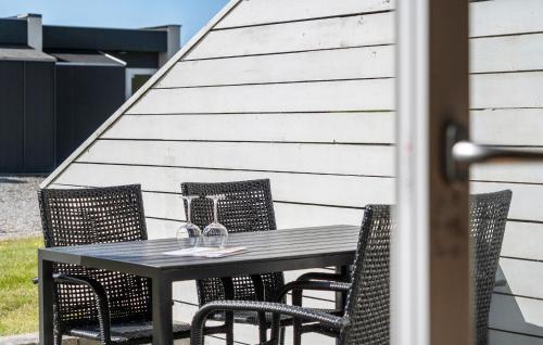 a black table and chairs on a patio at Nice Apartment In Vestervig With Sauna in Vestervig