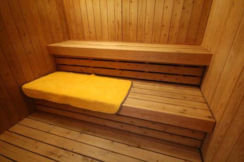 a small sauna with a yellow towel sitting in it at Nature Resort in Shimanto in Funato