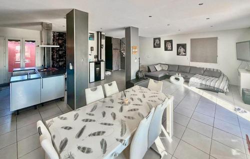 a kitchen and living room with a table and chairs at 4 Bedroom Beautiful Home In Rognac in Rognac