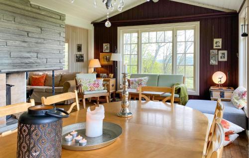 a living room with a table and a fireplace at 2 Bedroom Lovely Home In Oppdal in Oppdal