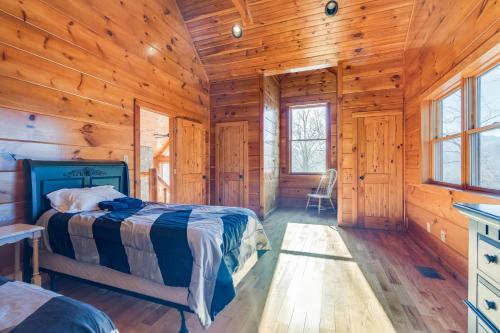 a bedroom with a bed in a wooden cabin at Majestic Manor - Peaceful Modern Cabin Retreat Near Watauga Lake in Butler