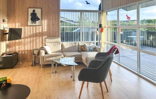 a living room with a couch and chairs and windows at Amazing Home In Tarm With Wifi in Tarm