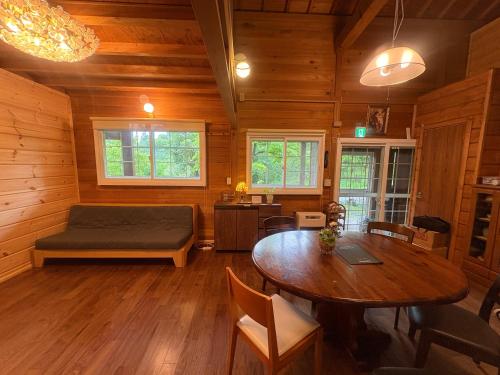 a room with a bed and a table in a cabin at beau lac biwako annex in Takashima