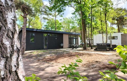 a house with a black exterior in the woods at Awesome Home In Hellendoorn With Wifi in Hellendoorn