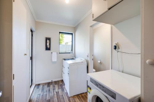 a laundry room with a washer and dryer at Village Close - prime location in Havelock North! in Havelock North