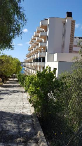 a sidewalk next to a building next to a building at TRH Jardín Del Mar in Santa Ponsa