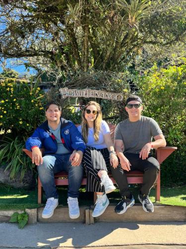 a group of people sitting on a park bench at Hotel Rholyn Pura Vida!! in Antigua Guatemala