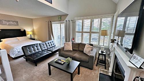 a living room with a bed and a couch at Freshly Upgraded Cozy Loft @ North Creek Resort in Blue Mountains
