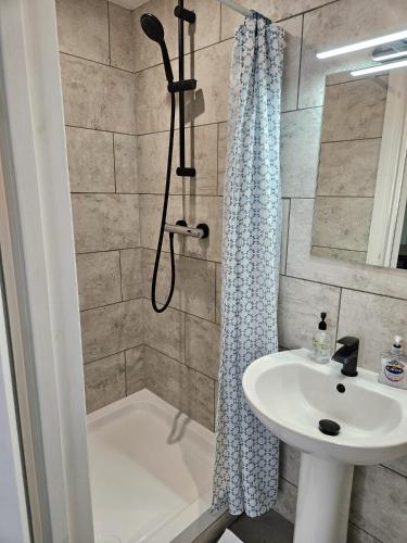a bathroom with a shower and a sink and a tub at Inn By The Sea, Portsmouth - EN SUITE Rooms with Sea View Possible, parking EV 22kW in Portsmouth