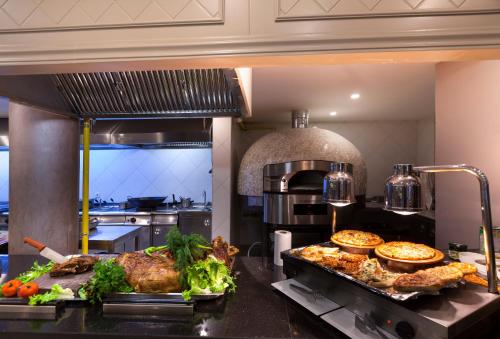 a kitchen with a buffet of food on a counter at Samara Hotel Bodrum Ultra All Inclusive in Torba