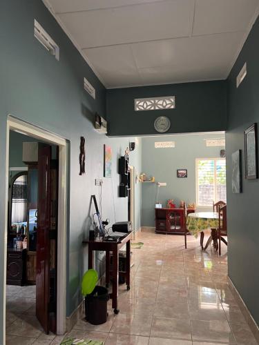 a living room with green walls and a desk at 288 Jeyamany Villa in Jaffna