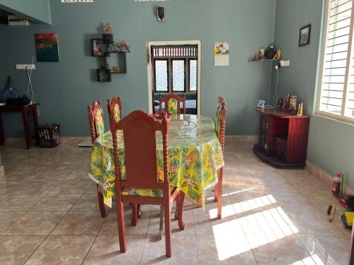 a dining room table with chairs and a table cloth at 288 Jeyamany Villa in Jaffna
