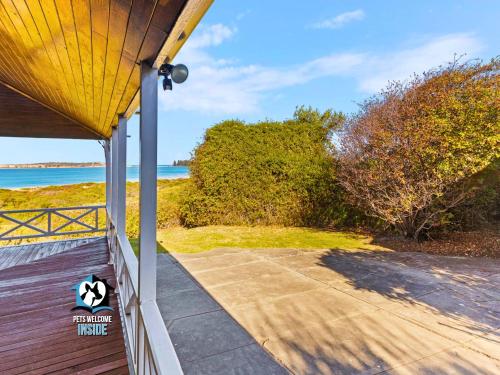 a porch of a house with a view of the ocean at Absolute Beachfront 3BR 2BA Home w/ Beach Track in McCracken