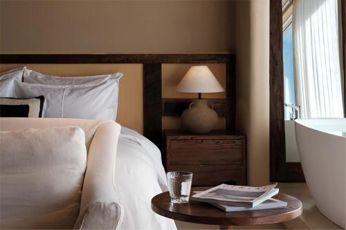 a bedroom with a bed and a table with a lamp at Dali Warm Dwellingt Hotel in Dali Ancient Town