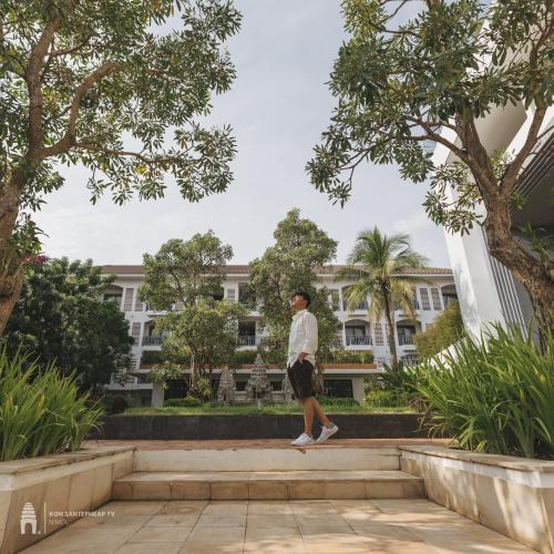 a man walking down some stairs in front of a building at Damrei Residence & Spa in Siem Reap