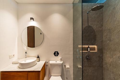 a bathroom with a toilet and a sink and a shower at Botanika Estate Private Pool Villa in Canggu