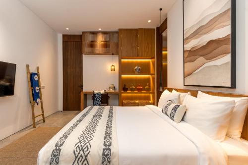 a bedroom with a large bed in a room at Botanika Estate Private Pool Villa in Canggu