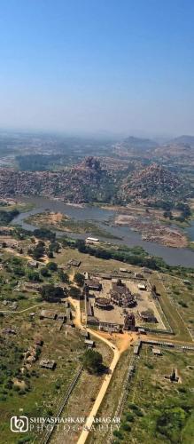 an aerial view of a town and a river at HAREKRISHNA GUESTHOUSE HAMPi in Hampi