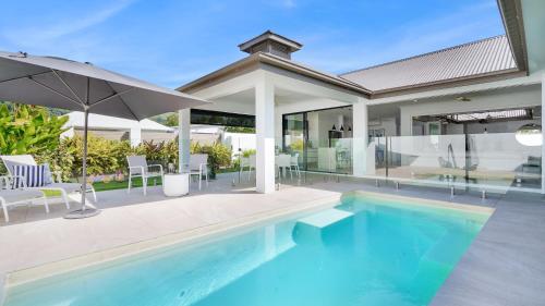 an image of a swimming pool in a house at Pura Villa - Tropical Luxury Living in Palm Cove